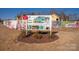 Sign showcasing upcoming community amenities including a pool and recreation areas, set against new homes at 11031 Larkslea Ln, Charlotte, NC 28278
