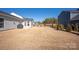 Spacious backyard with manicured lawn, trees, and fence, perfect for outdoor enjoyment at 11031 Larkslea Ln, Charlotte, NC 28278