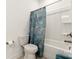 Clean bathroom featuring a shower-tub combo with a decorative curtain at 11031 Larkslea Ln, Charlotte, NC 28278