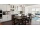 Dining area with a large wooden table, white cabinets, and a wine rack at 11031 Larkslea Ln, Charlotte, NC 28278