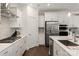 Updated kitchen boasts white cabinets, stainless steel appliances, and modern fixtures at 11031 Larkslea Ln, Charlotte, NC 28278