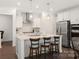 Island in a bright kitchen featuring stainless appliances, pendant lights, and seating at 11031 Larkslea Ln, Charlotte, NC 28278