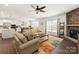 Cozy living room with a stone fireplace, dark wood floors, and an open floorplan at 11031 Larkslea Ln, Charlotte, NC 28278