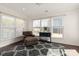 Bright living room with a comfortable chair, modern rug, and lots of natural light at 11031 Larkslea Ln, Charlotte, NC 28278