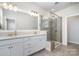 En suite bathroom features dual vanity, granite counters, modern fixtures, and a glass-enclosed shower at 11537 Red Rust Ln, Charlotte, NC 28277