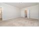 Large bedroom with neutral carpet, ample closet space, and direct access to the en suite bathroom at 11537 Red Rust Ln, Charlotte, NC 28277