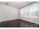 Sunlit bedroom with gleaming hardwood floors and large windows dressed with sheer curtains at 11537 Red Rust Ln, Charlotte, NC 28277