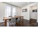 Cozy dining area with wood table, chairs, modern decor, and lots of natural light at 11537 Red Rust Ln, Charlotte, NC 28277