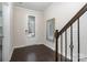 Inviting entryway with a decorative mirror, dark wood floors and a glass-paneled front door at 11537 Red Rust Ln, Charlotte, NC 28277