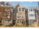 A welcoming townhome with a classic brick facade, landscaped yard, and charming balcony at 11537 Red Rust Ln, Charlotte, NC 28277