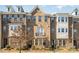 Charming brick townhome featuring a small balcony and well-maintained landscaping at 11537 Red Rust Ln, Charlotte, NC 28277