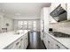 Bright kitchen boasts white cabinets, stainless steel appliances, a quartz countertop island, and modern finishes at 11537 Red Rust Ln, Charlotte, NC 28277