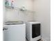 Modern laundry room with a large capacity washer and dryer and overhead storage shelf at 11537 Red Rust Ln, Charlotte, NC 28277