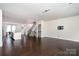 Spacious living room featuring hardwood floors, staircase, and an open layout at 11537 Red Rust Ln, Charlotte, NC 28277