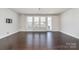Hardwood floors and natural light complement this living area with large windows and a door at 11537 Red Rust Ln, Charlotte, NC 28277