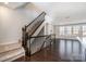 Open-concept living area with hardwood floors, staircase, and lots of natural light at 11537 Red Rust Ln, Charlotte, NC 28277