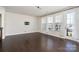 Bright living room with hardwood flooring, large windows, a TV mount, and lots of natural light at 11537 Red Rust Ln, Charlotte, NC 28277
