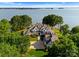 Expansive lakefront estate featuring a large lawn, mature trees and beautiful architectural design at 124 Wellcraft Ct, Mooresville, NC 28117
