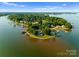 Stunning aerial view of waterfront home with lush greenery and private dock on a serene lake at 124 Wellcraft Ct, Mooresville, NC 28117