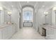 Elegant bathroom with marble floors, dual vanities, a soaking tub, and a chandelier at 124 Wellcraft Ct, Mooresville, NC 28117