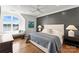 Stylish bedroom with a gray accent wall, a window bench, and a large window with lake views at 124 Wellcraft Ct, Mooresville, NC 28117