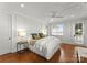 Bright bedroom features hardwood floors, a ceiling fan, a window, and a French door at 124 Wellcraft Ct, Mooresville, NC 28117