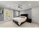 Cozy bedroom with a queen-size bed, a ceiling fan, and french doors that lead to the outside at 124 Wellcraft Ct, Mooresville, NC 28117