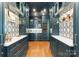 Stylish butler's pantry featuring custom blue cabinetry, wine fridge, sleek countertops, and patterned backsplash at 124 Wellcraft Ct, Mooresville, NC 28117