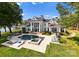 Aerial view of a grand waterfront estate with a pool, hot tub, and manicured landscaping at 124 Wellcraft Ct, Mooresville, NC 28117