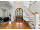 Grand foyer with hardwood floors, staircase, and beautiful arched front doors at 124 Wellcraft Ct, Mooresville, NC 28117