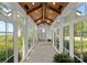 Light filled hallway with stone floors, multiple windows, wood ceiling and a view of the outdoor greenery at 124 Wellcraft Ct, Mooresville, NC 28117
