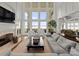 Spacious living room with high ceilings, large windows, fireplace, and lake views at 124 Wellcraft Ct, Mooresville, NC 28117