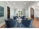 Inviting living room with serene decor, large windows, comfortable seating, and view to backyard at 124 Wellcraft Ct, Mooresville, NC 28117