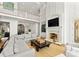 Bright living room featuring high ceilings, fireplace, large windows, and lake views at 124 Wellcraft Ct, Mooresville, NC 28117