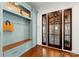 The mud room features custom cabinetry, a built-in bench, coat hooks and a view of the entryway at 124 Wellcraft Ct, Mooresville, NC 28117