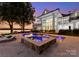 Inviting pool area with a spa, comfortable seating, and picturesque views of the lake at 124 Wellcraft Ct, Mooresville, NC 28117