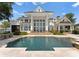 Stunning rear exterior featuring a pool and covered patio with lake views at 124 Wellcraft Ct, Mooresville, NC 28117