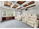 Home theater with comfortable seating, coffered ceiling, large windows and a view of the well manicured landscape at 124 Wellcraft Ct, Mooresville, NC 28117