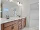 Double vanity with wood cabinets, white quartz countertops, and modern lighting at 1279 Kindness Nw Ct, Concord, NC 28027