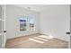 Sunlit bedroom with large window offering a view of the neighborhood at 1279 Kindness Nw Ct, Concord, NC 28027