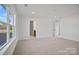 Spacious carpeted bedroom with large window and ensuite bathroom access at 1279 Kindness Nw Ct, Concord, NC 28027
