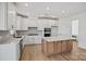 Bright kitchen featuring white cabinets, an island, stainless steel appliances, and stylish backsplash at 1279 Kindness Nw Ct, Concord, NC 28027