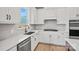 Bright kitchen featuring white cabinets, stainless steel appliances, island, and stylish backsplash at 1279 Kindness Nw Ct, Concord, NC 28027