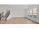 Expansive living room with stairs leading to the second floor and large windows at 1279 Kindness Nw Ct, Concord, NC 28027
