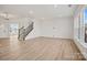 Open-concept living room with stairs and a glimpse of the kitchen at 1279 Kindness Nw Ct, Concord, NC 28027