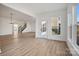 Open living area with wood floors, natural light, and views of the staircase at 1279 Kindness Nw Ct, Concord, NC 28027