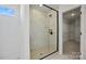 Frameless glass shower with neutral tile and built in shampoo niche at 1279 Kindness Nw Ct, Concord, NC 28027