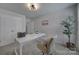 Modern home office showcases a sleek white desk, comfortable chair, and ample natural light at 128 Briana Marie Way, Indian Trail, NC 28079