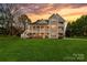 Expansive backyard featuring multi-story porch and spacious lawn at 12860 Westmoreland Farm Rd, Davidson, NC 28036