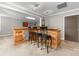 Cozy bar area featuring a wood and stone bar with seating for three at 12860 Westmoreland Farm Rd, Davidson, NC 28036